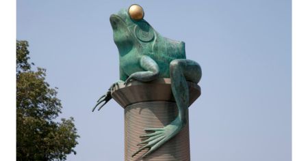 One of four bronze frog statues on Willimantic’s “Frog Bridge,” perched atop a thread spool to symbolize the town’s textile heritage and legendary 1754 frog folklore.