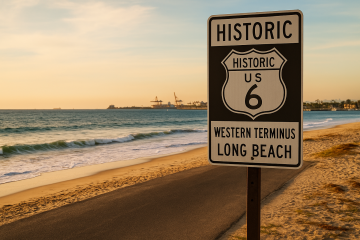 Western terminus of Historic US Route 6 in Long Beach with ocean waves and Route 6 shield sign in October sunlight.